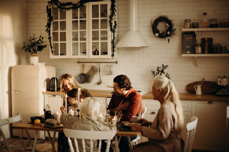 family-sits-on-table-inside-kitchen-3171153