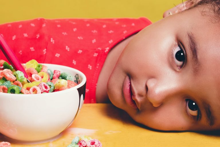 girl-wearing-red-shirt-lying-on-table-beside-white-bowl-with-2055748 dete reklama